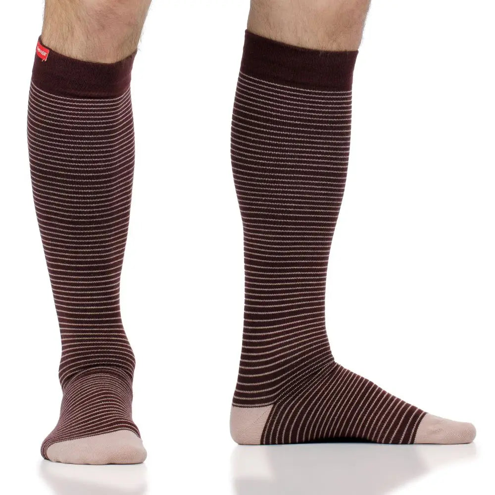 Brown striped knee-high compression socks worn by a person on a white background