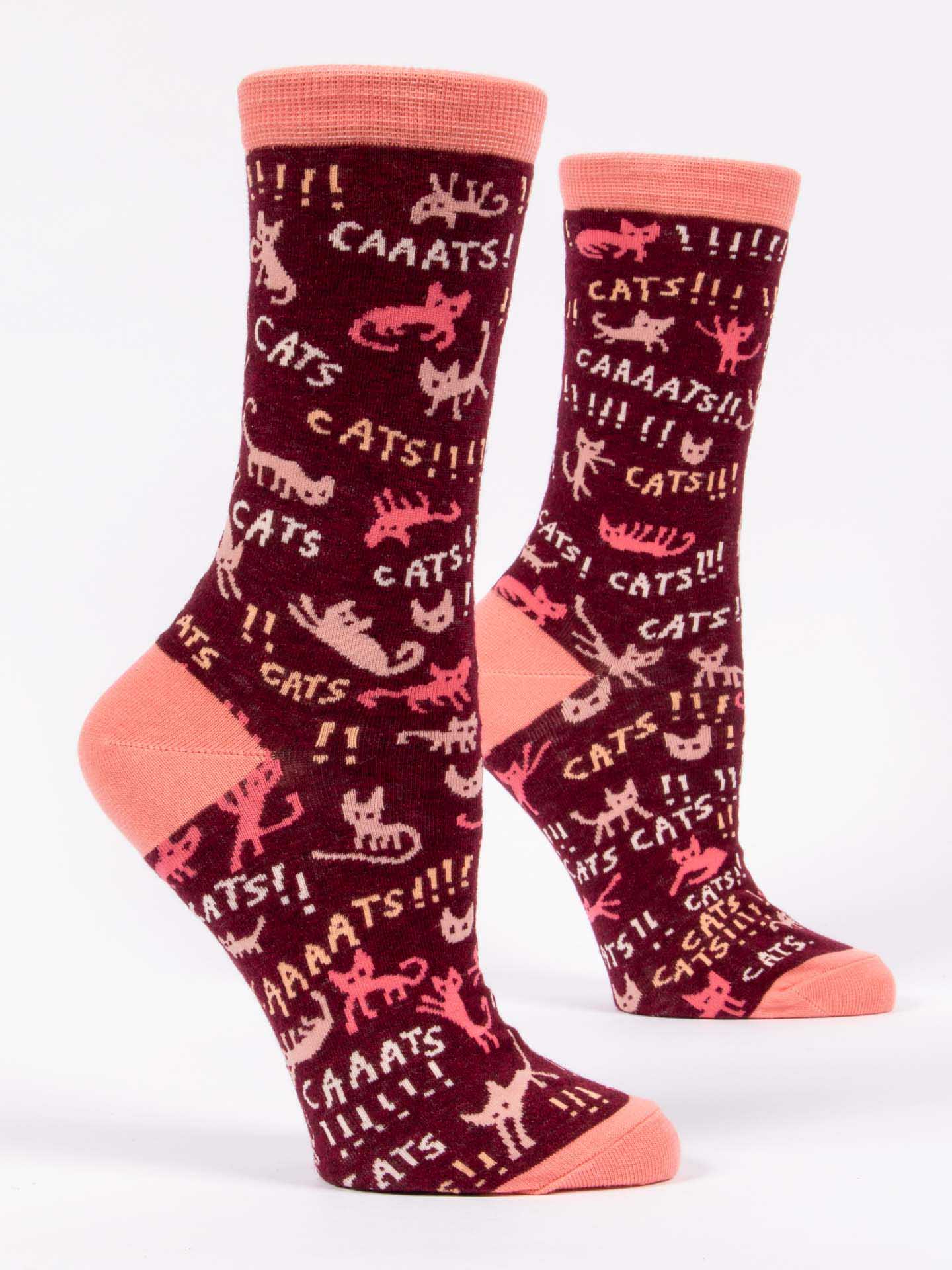 Pair of socks with cat pattern and pink accents on a white background