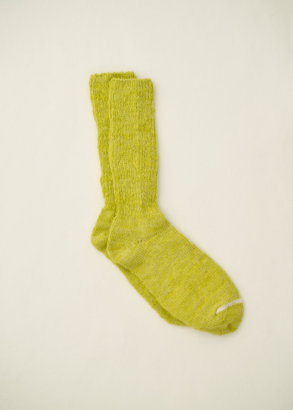 Green sock on a beige background