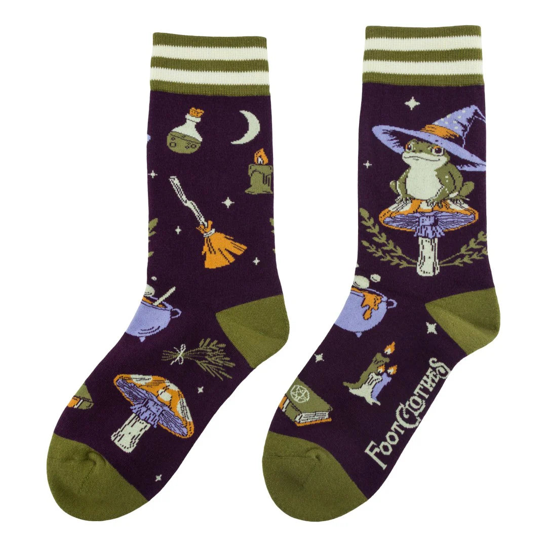 Pair of socks with witch-themed design on a white background