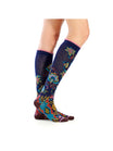 Colorful patterned socks worn by a person on a white background