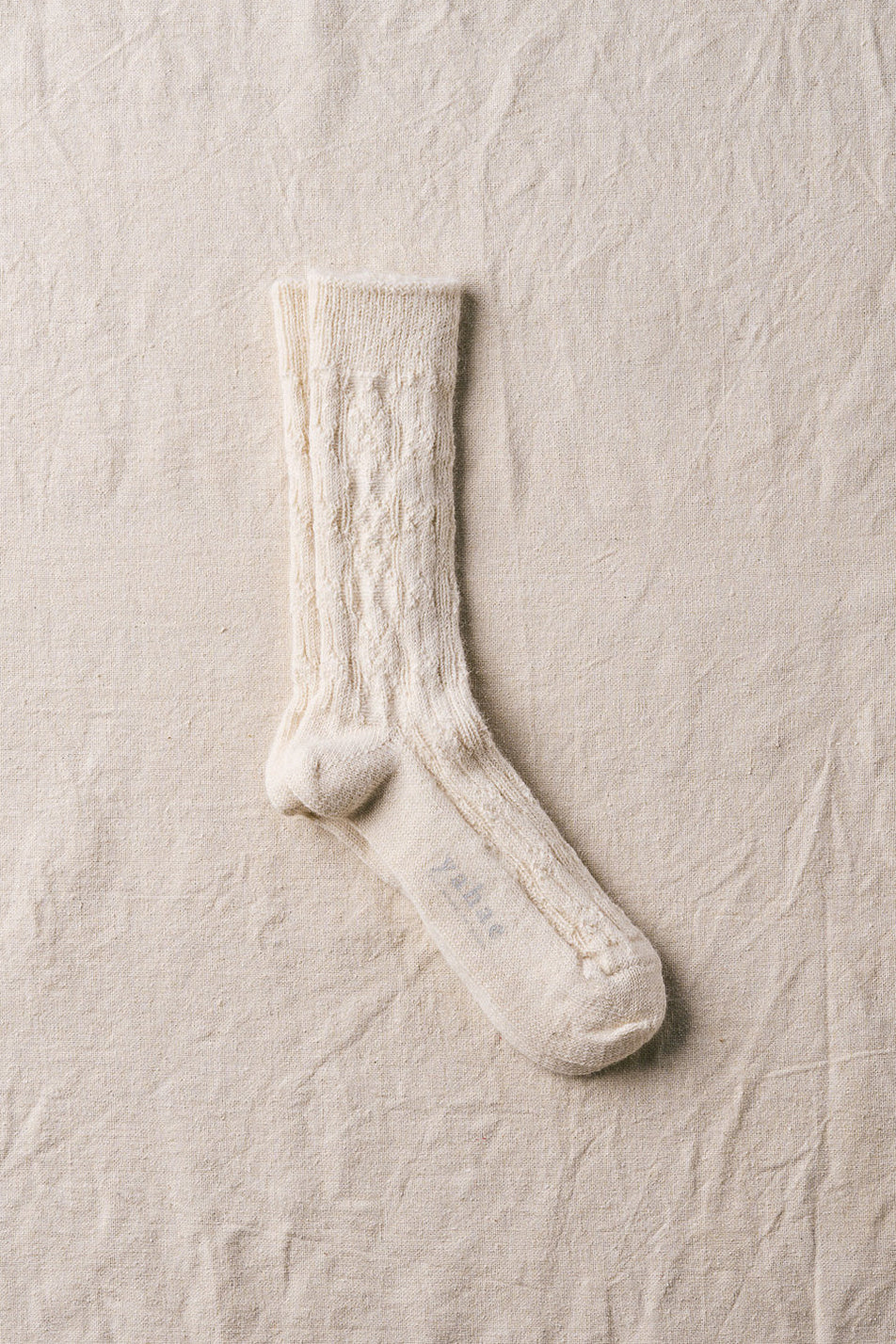 White sock on a textured beige background