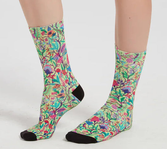 Colorful floral-patterned socks worn by a person on a white background