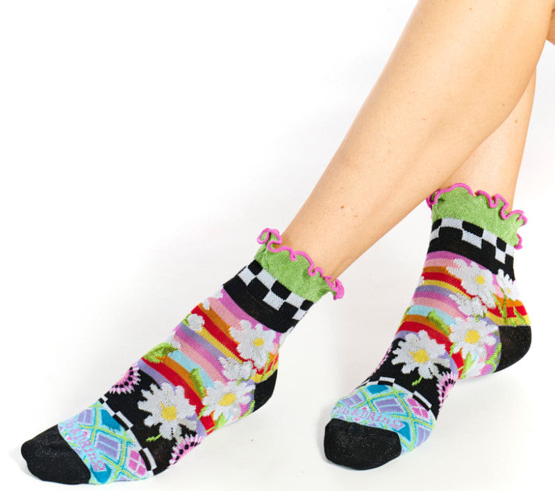 Colorful patterned socks worn by a person on a white background