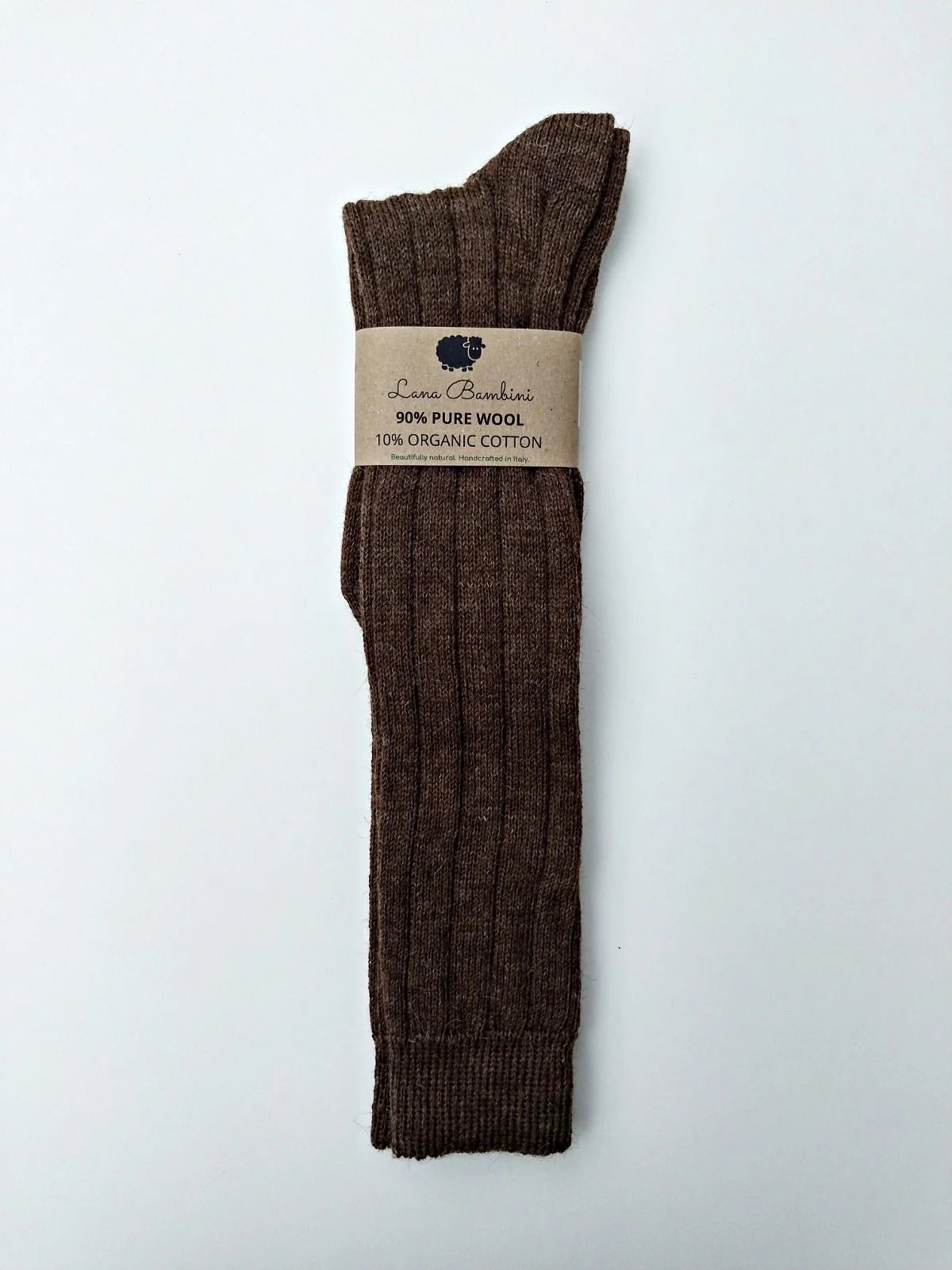 Brown knee high socks with a label on a white background
