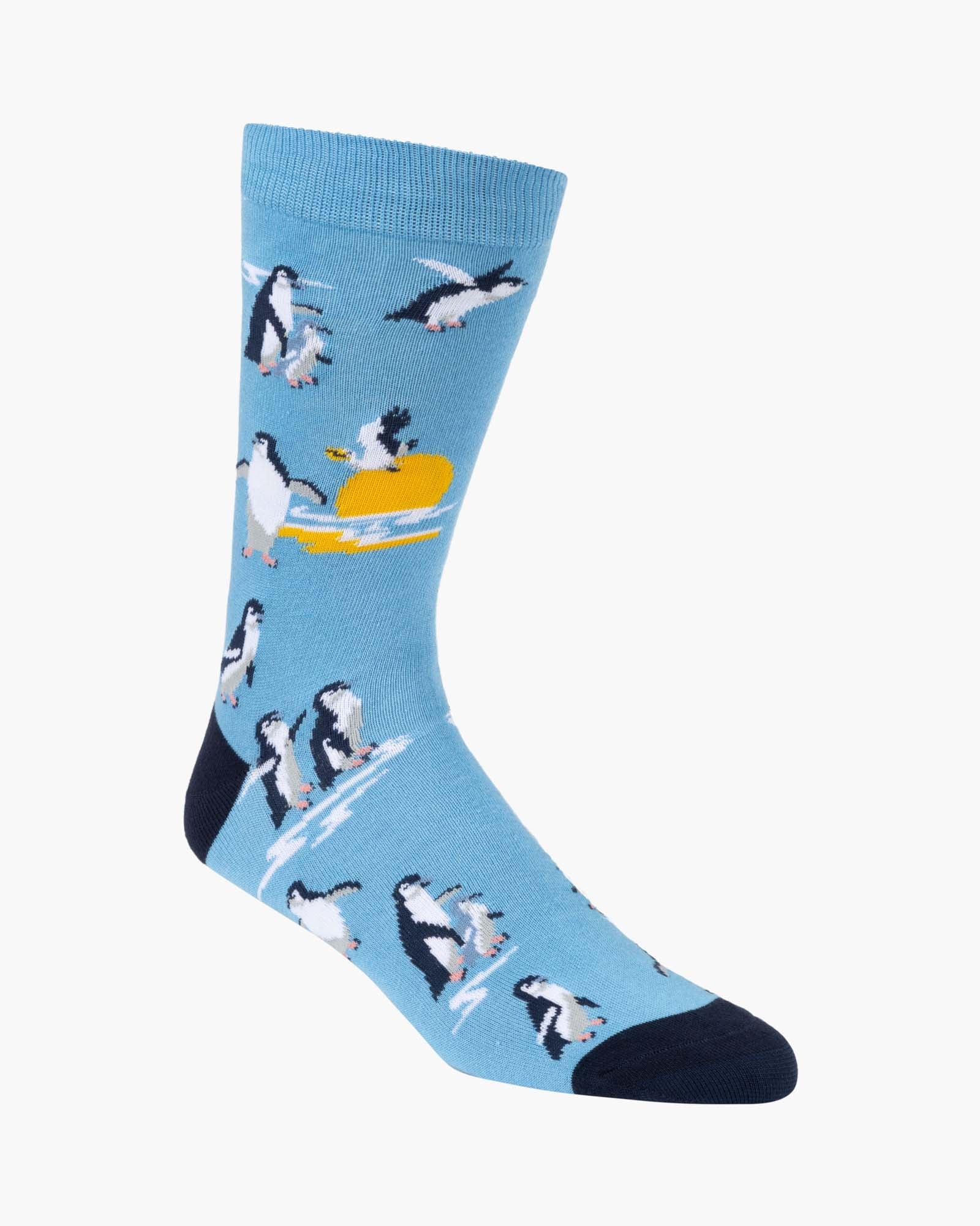 Blue sock with penguin design on a white background