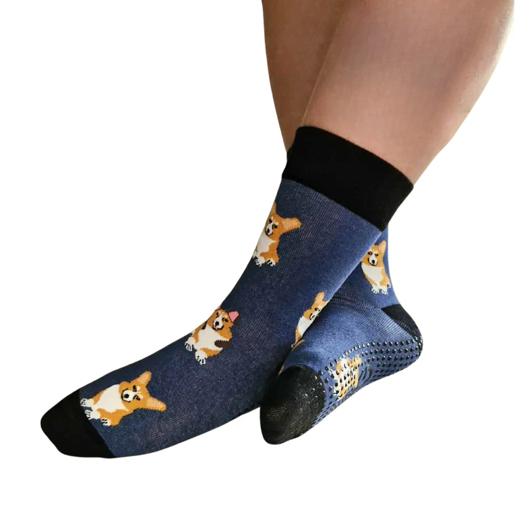 Blue socks with corgi dog pattern worn by a person on a white background