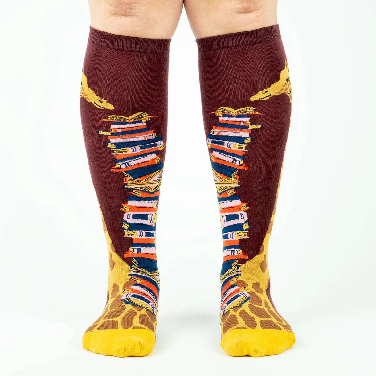Knee-high socks with book and giraffe pattern on a white background