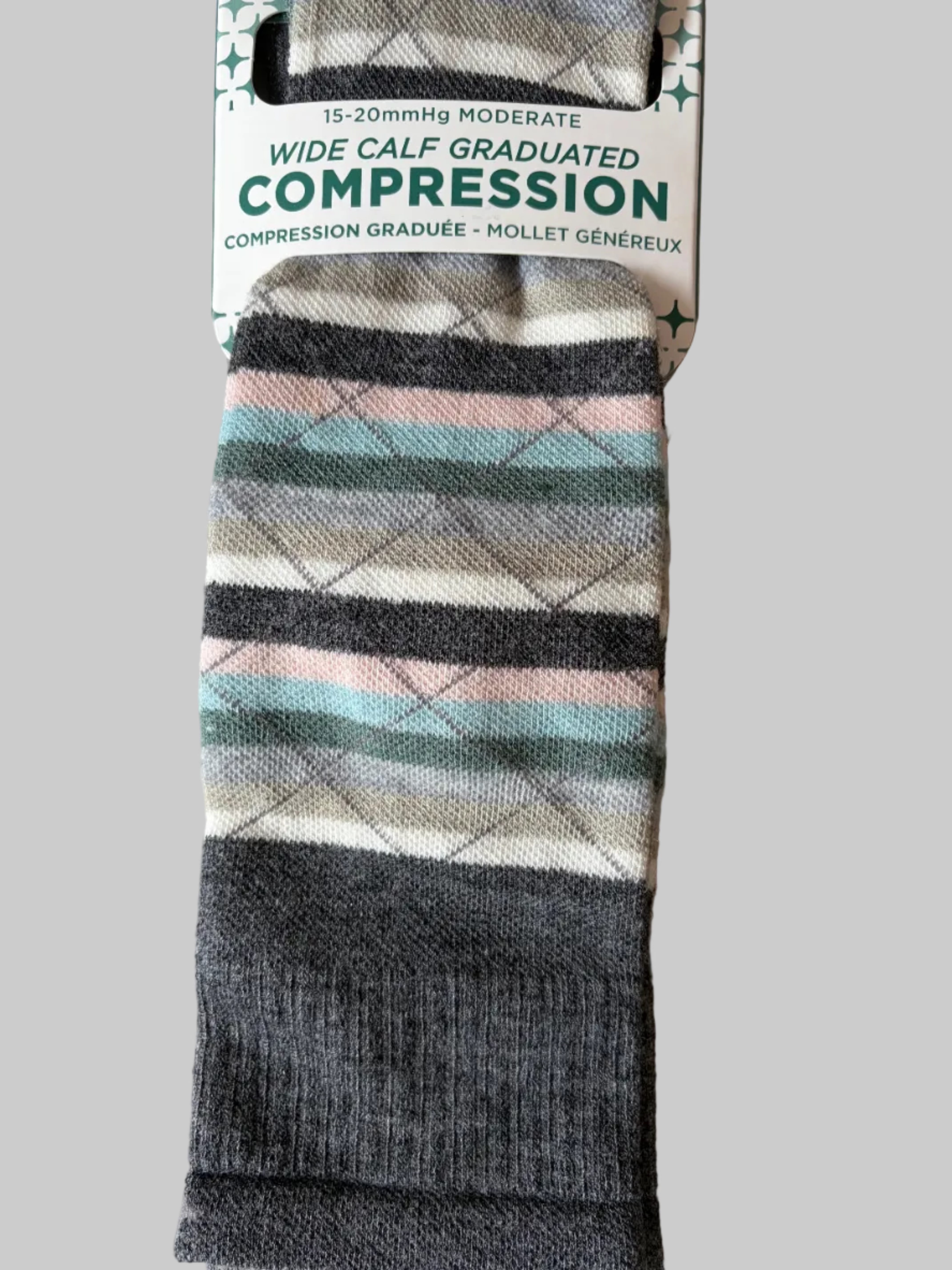 Striped compression sock with packaging on a beige background