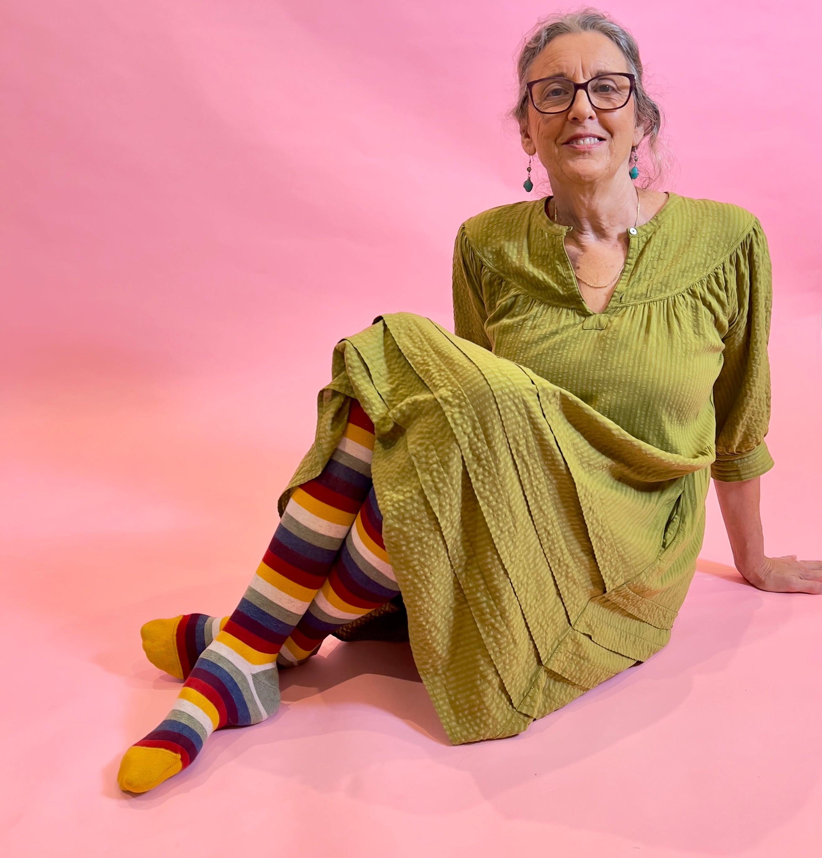 woman wearing autumn striped socks and a green dress - The Sockery
