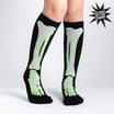 Black knee-high socks with green skeleton design on a white background