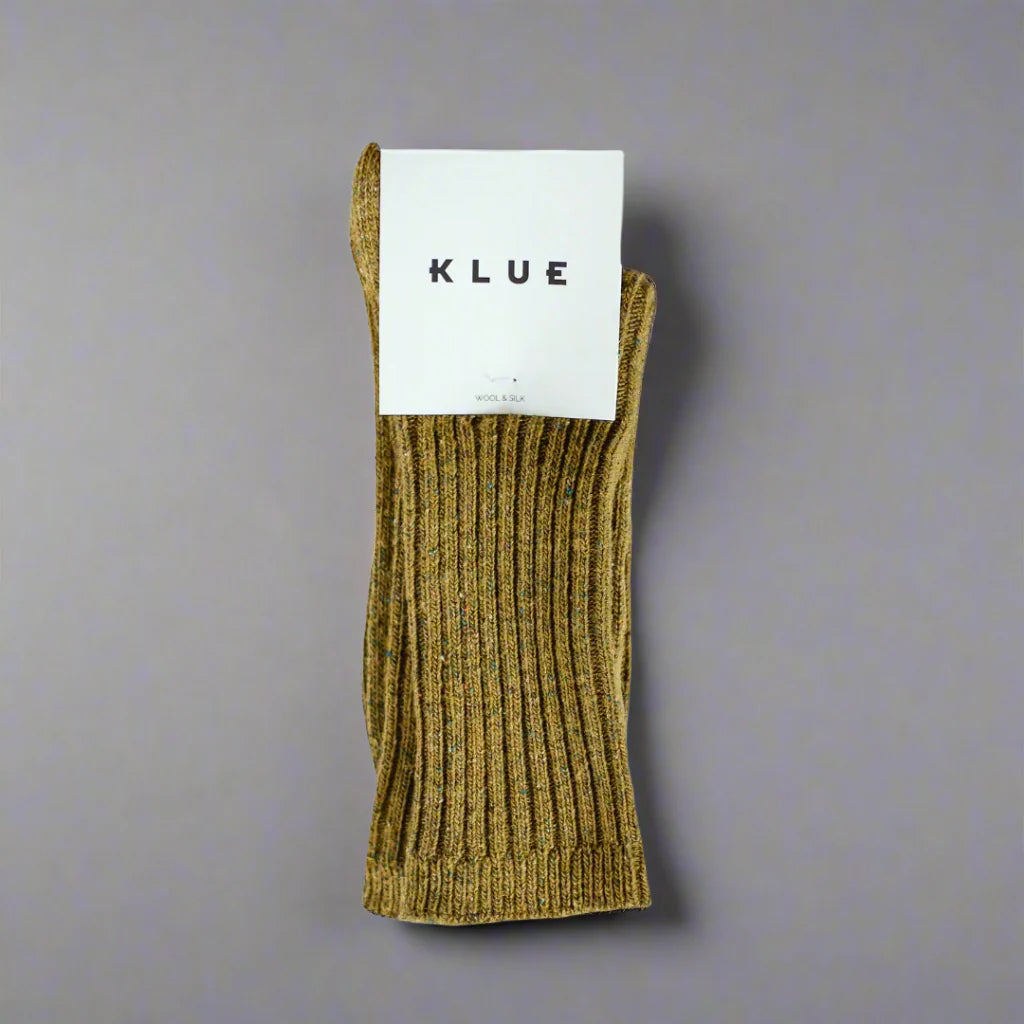 Khaki sock with a KLUE label on a gray background
