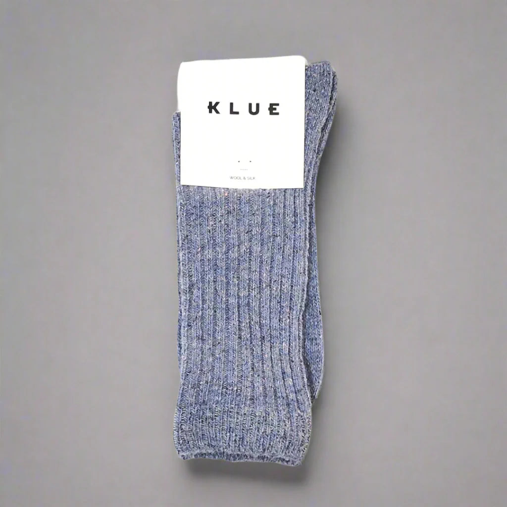 Pair of gray socks with a KLUE label on a gray background