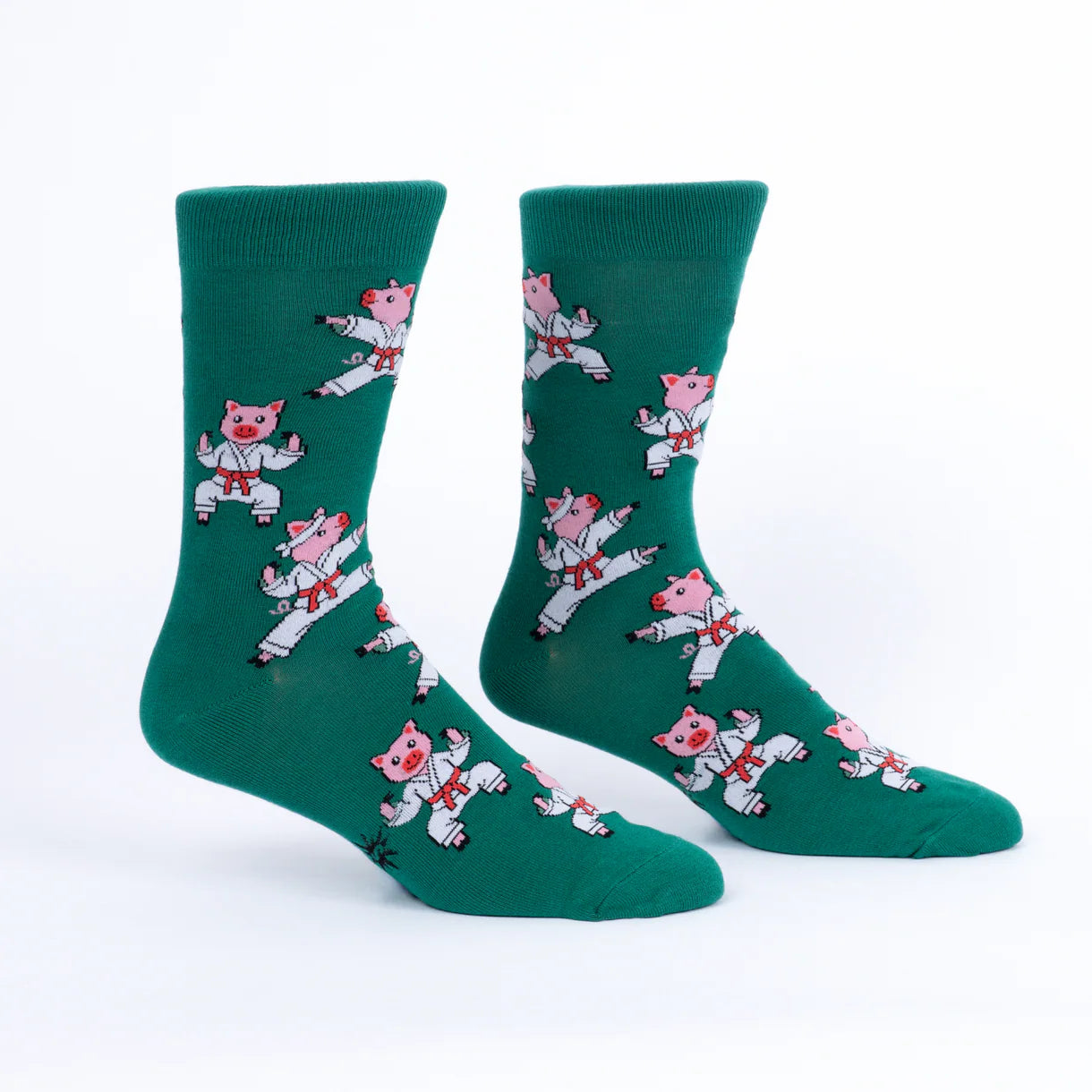 Green socks with cartoon pig designs on a white background