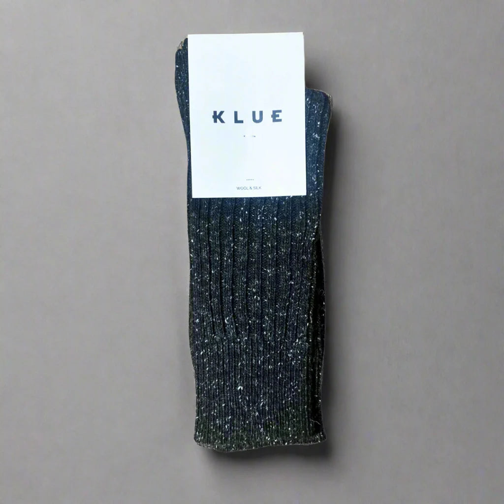 Dark gray sock with a KLUE label on a gray background