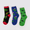 Three pairs of socks with dinosaur patterns on a light gray background