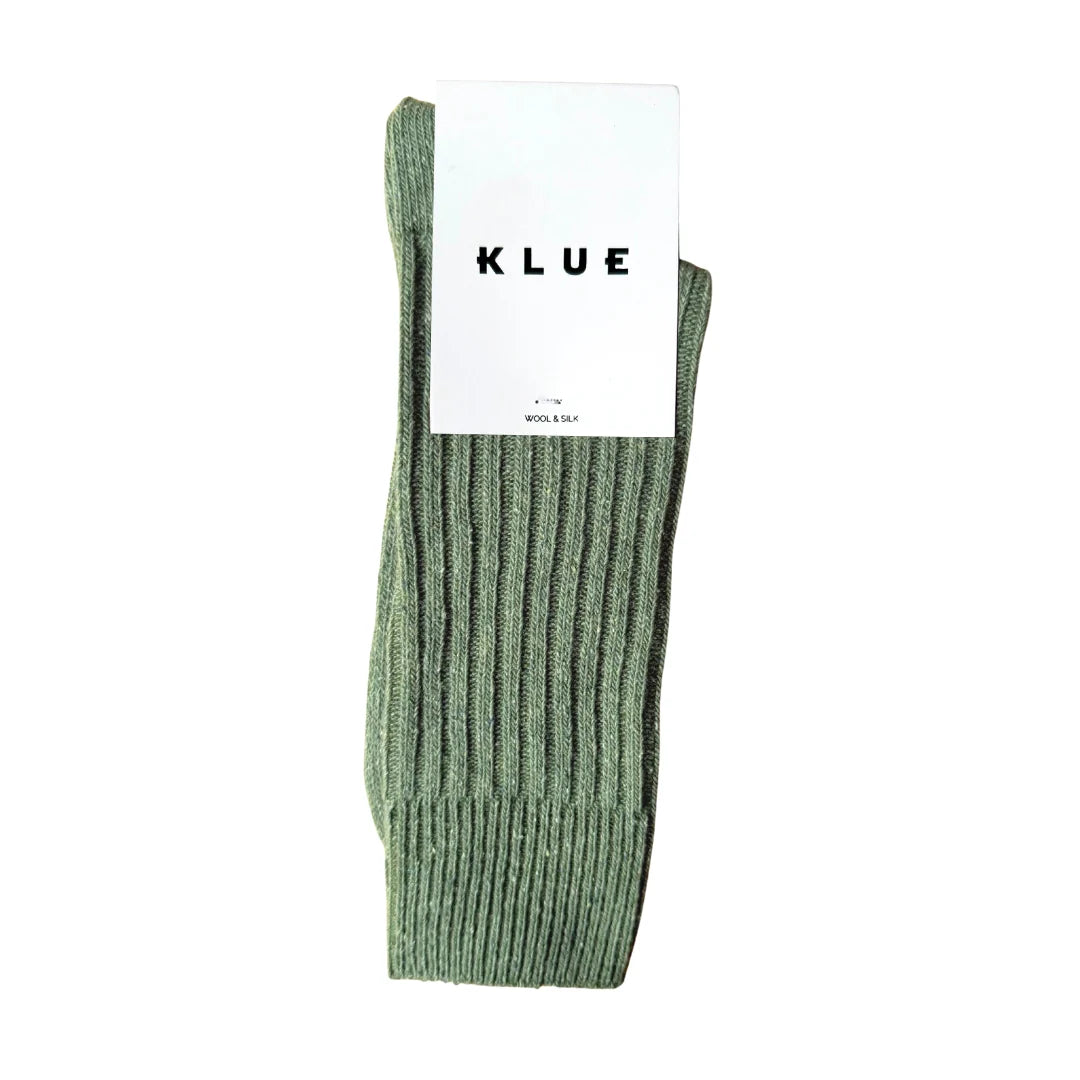 Green sock with a KLUE label on a white background