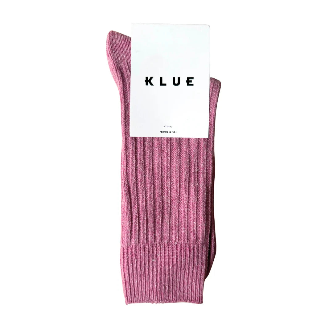 Pink sock with KLUE label on a white background