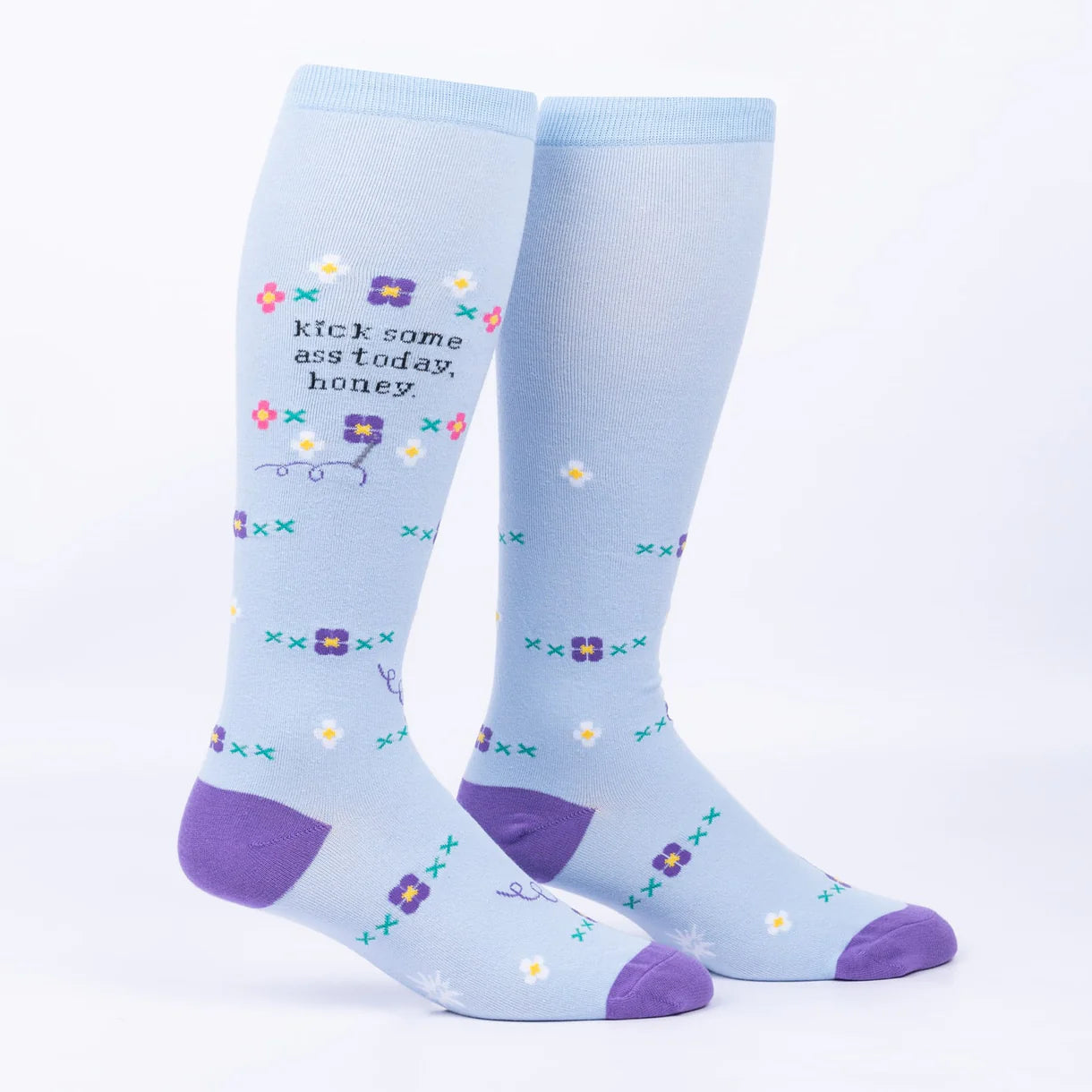 Light blue socks with purple accents and floral patterns on a white background