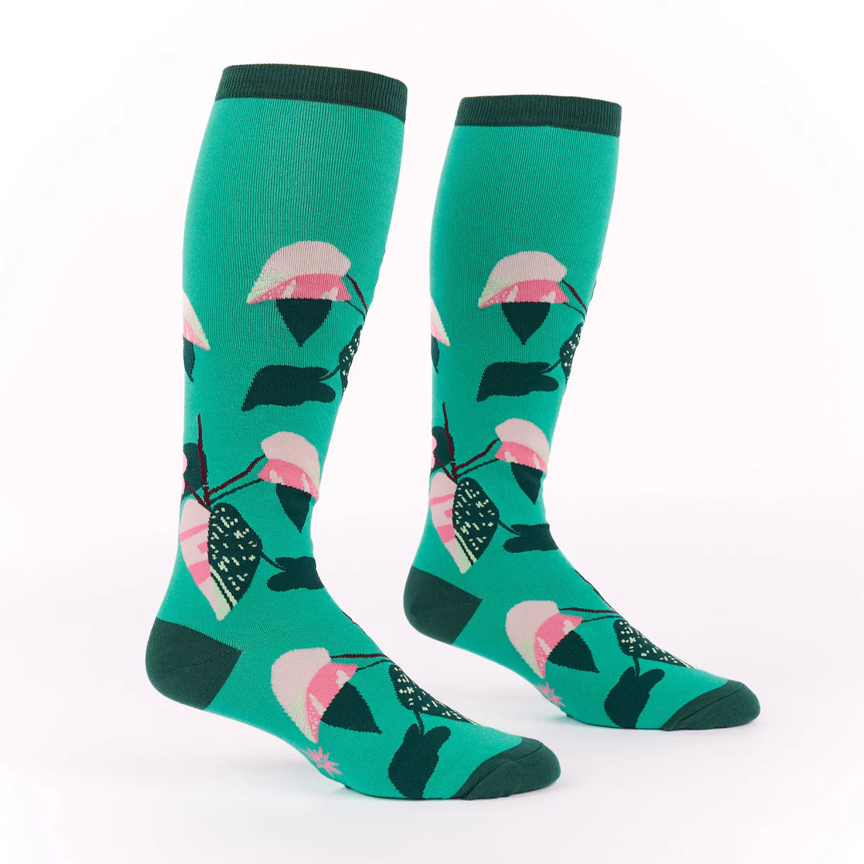 Green knee-high socks with pink and black leaf pattern on a white background