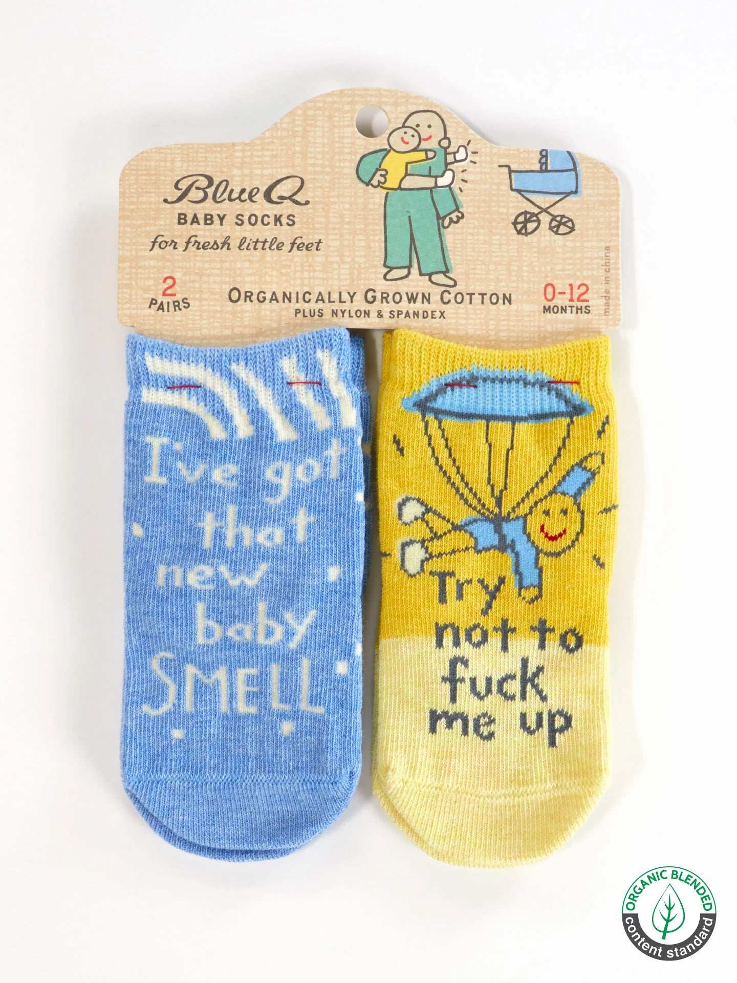 Two pairs of baby socks with humorous text on a branded package.