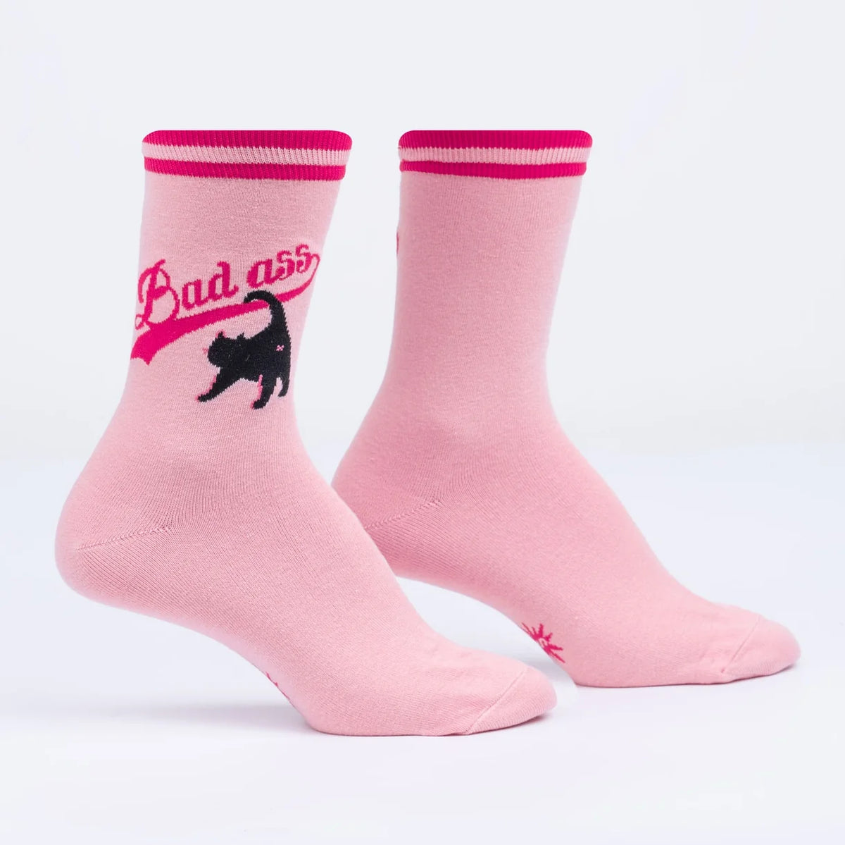 Pink socks with "bad ass" writing and a black cat's bum