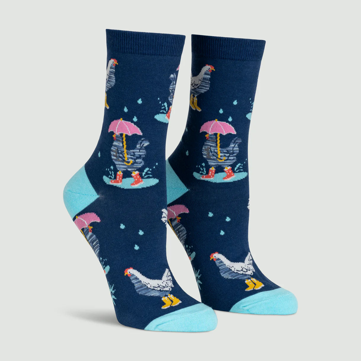 Pair of socks with a chicken design holding an umbrella on a light gray background