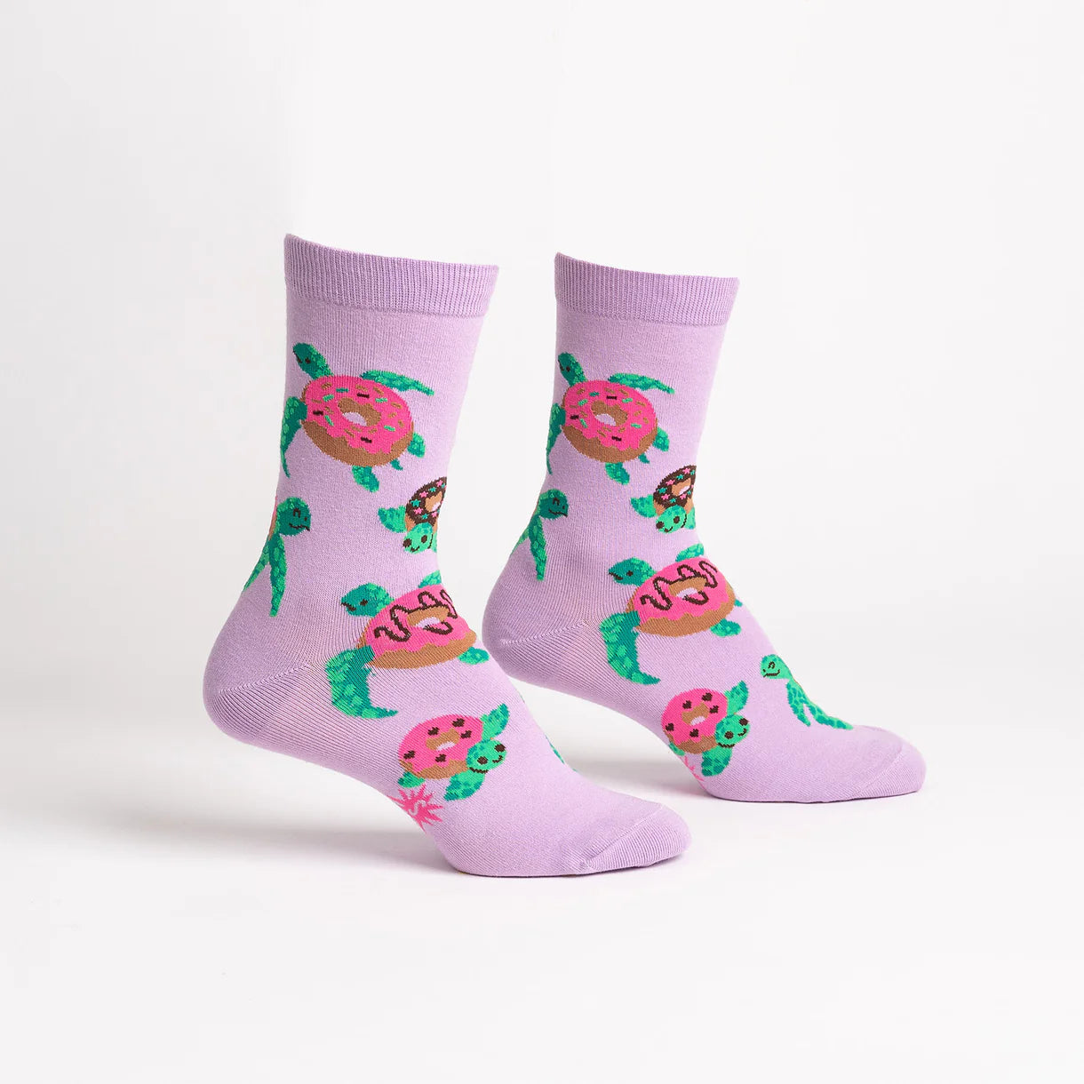 Pair of socks with turtle and donut design on a light purple background