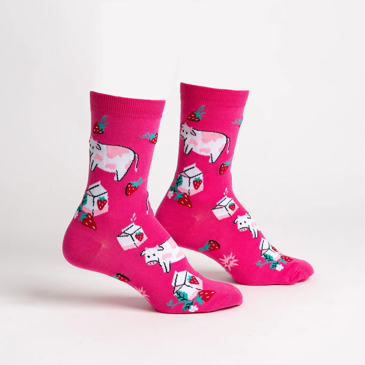 Pink socks with a strawberry milk design and cows