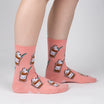 Pink socks with cat-themed designs on a plain background