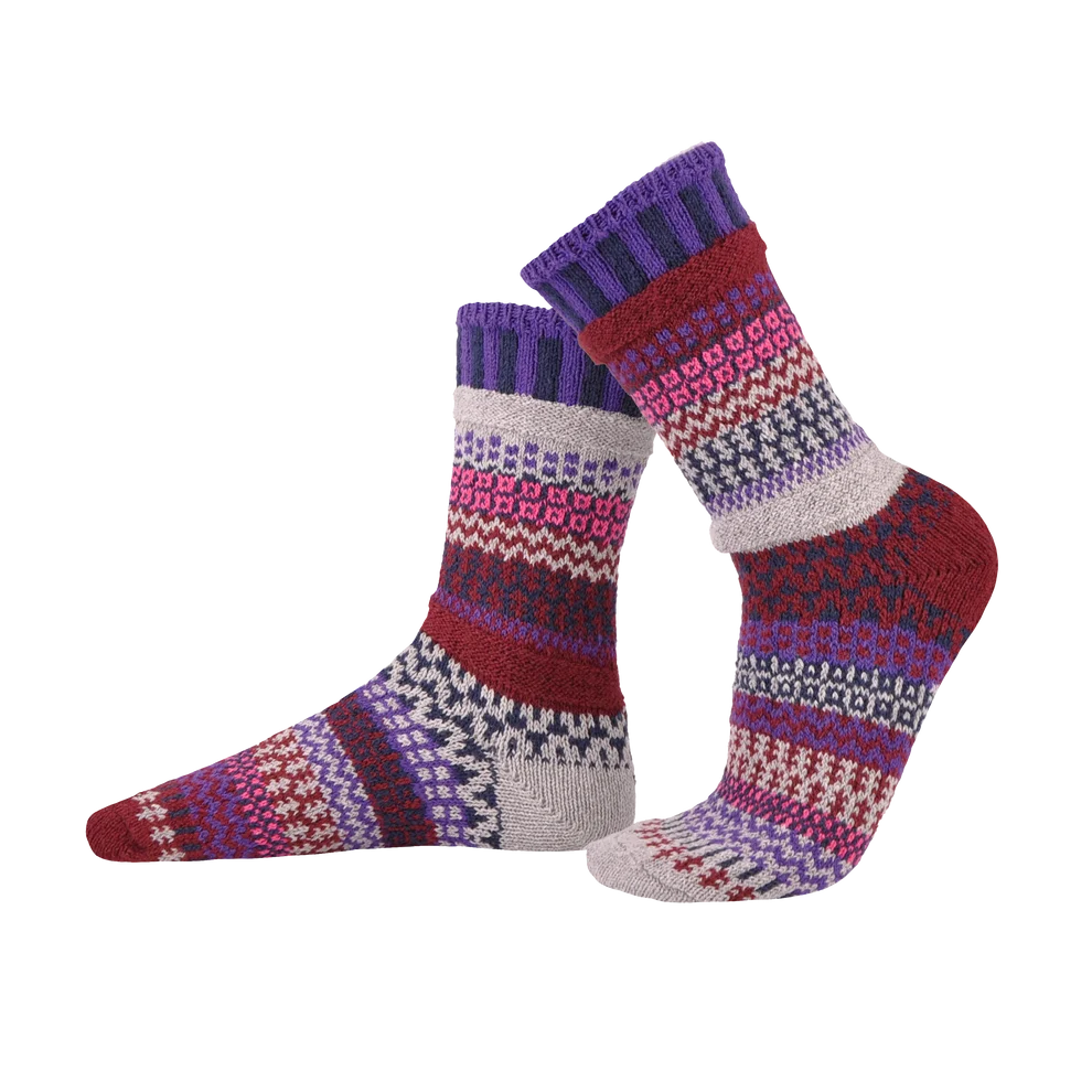 A pair of crew socks with a multicolor pattern featuring purple, red, pink, white, and gray stripes, shown against a plain white background.