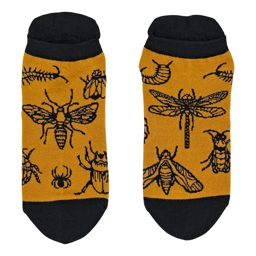 Pair of socks with insect pattern on a mustard yellow background