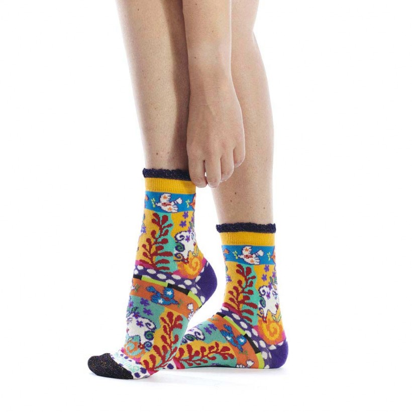 Colorful patterned socks worn by a person on a white background