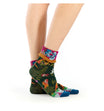 Colorful patterned socks worn by a person on a white background
