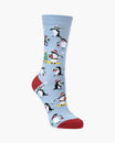 A single light blue crew sock with a festive penguin pattern, featuring red heels and toes, displayed on a clean white background.