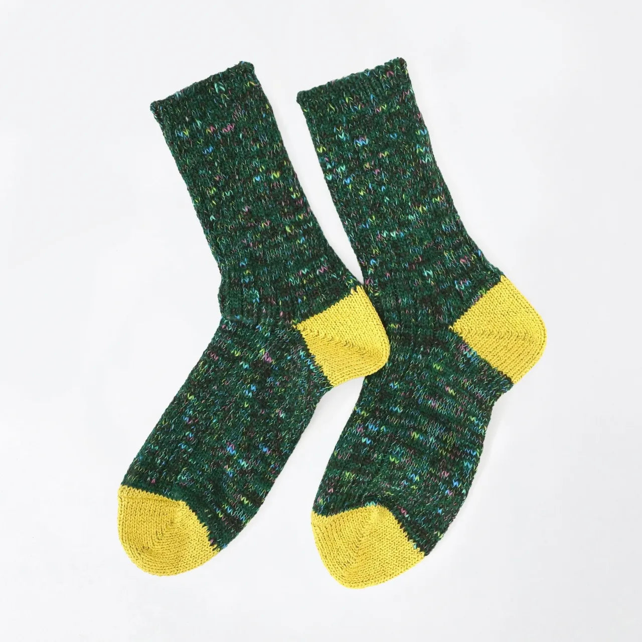 Pair of green socks with yellow toes and cuffs on a white background