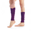 Purple leg warmers worn by a person on a white background