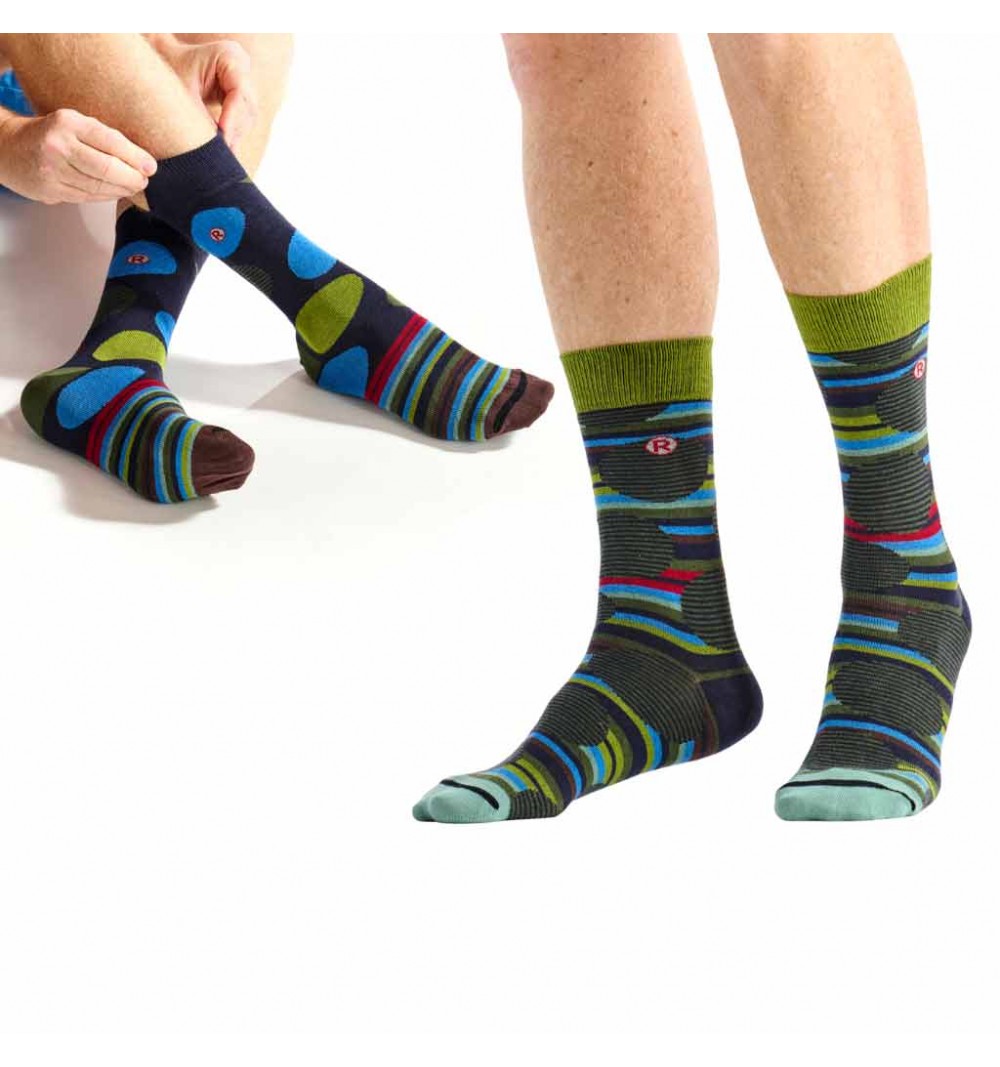Colorful patterned socks worn by a person on a white background
