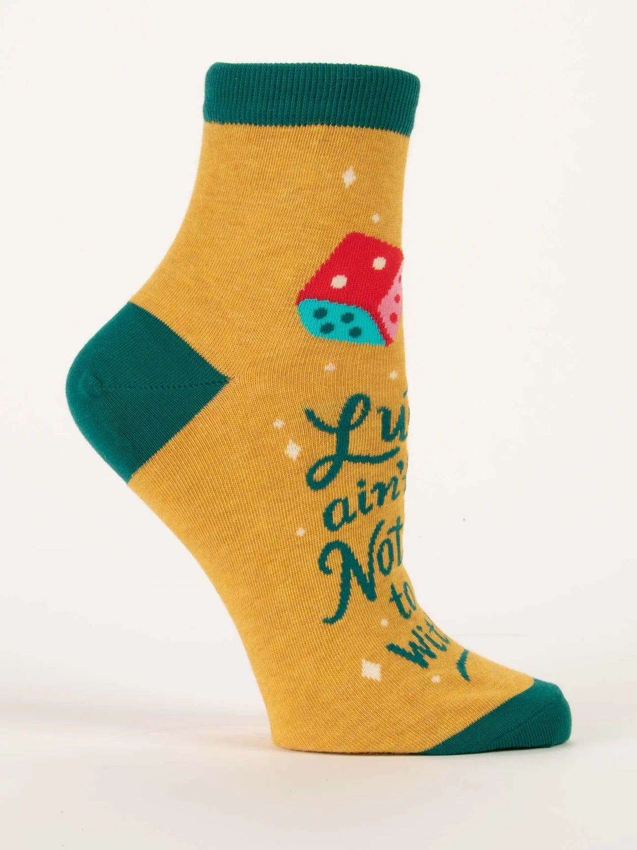 Yellow sock with green cuff and sole, featuring a dice and text on a white background