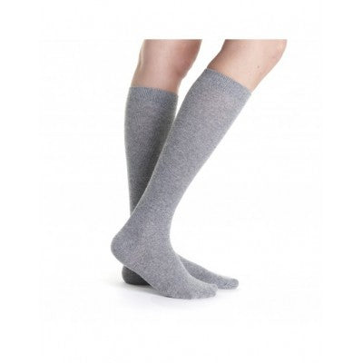 Gray knee-high socks worn by a person on a white background