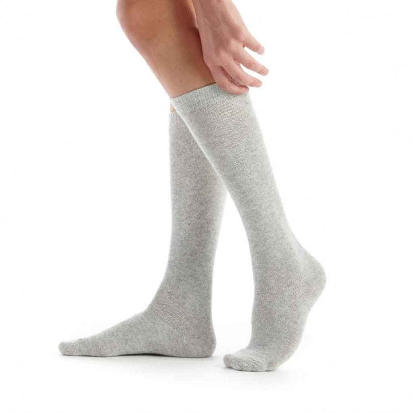 Gray knee-high socks worn by a person on a white background