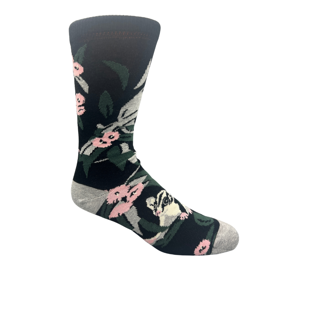 socks with possum and floral design on a black background