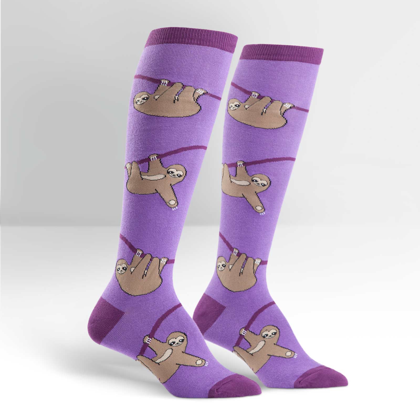 Purple knee high socks with brown sloths hanging from purple branches - The Sockery