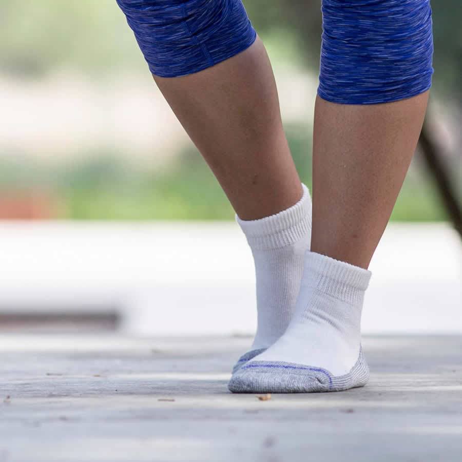 Woman in leggings wearing loose fit quarter length socks in white - The Sockery