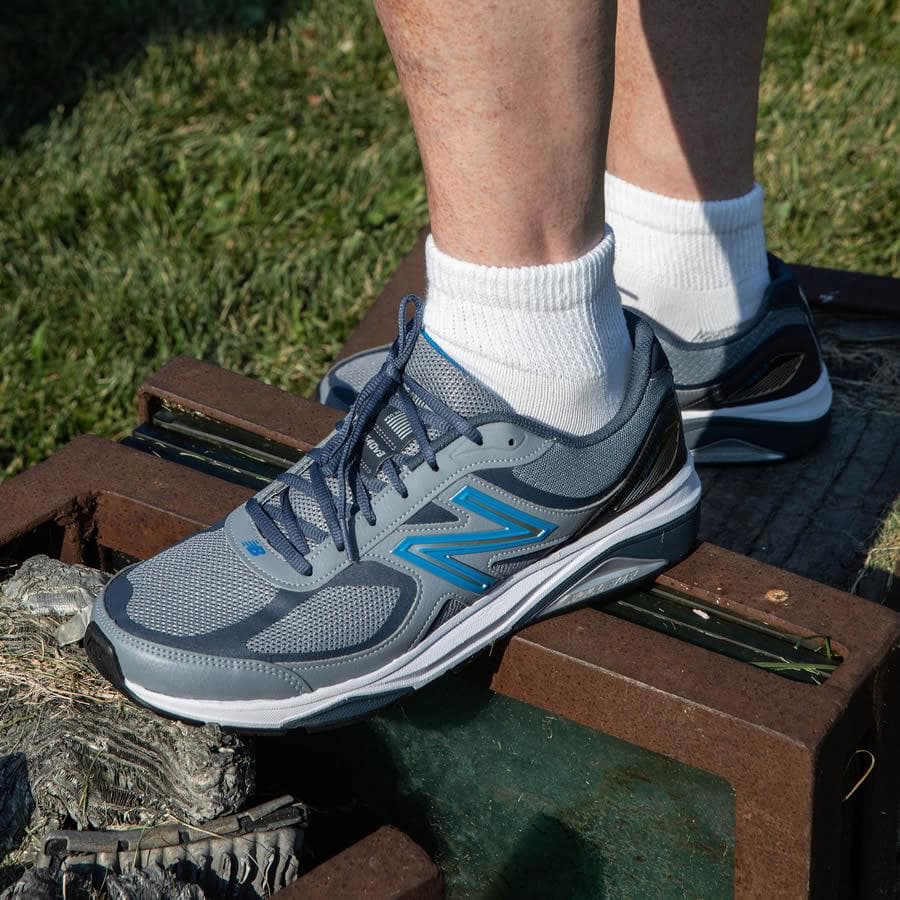 Person wearing sneakers and loose fit white quarter length socks - The Sockery