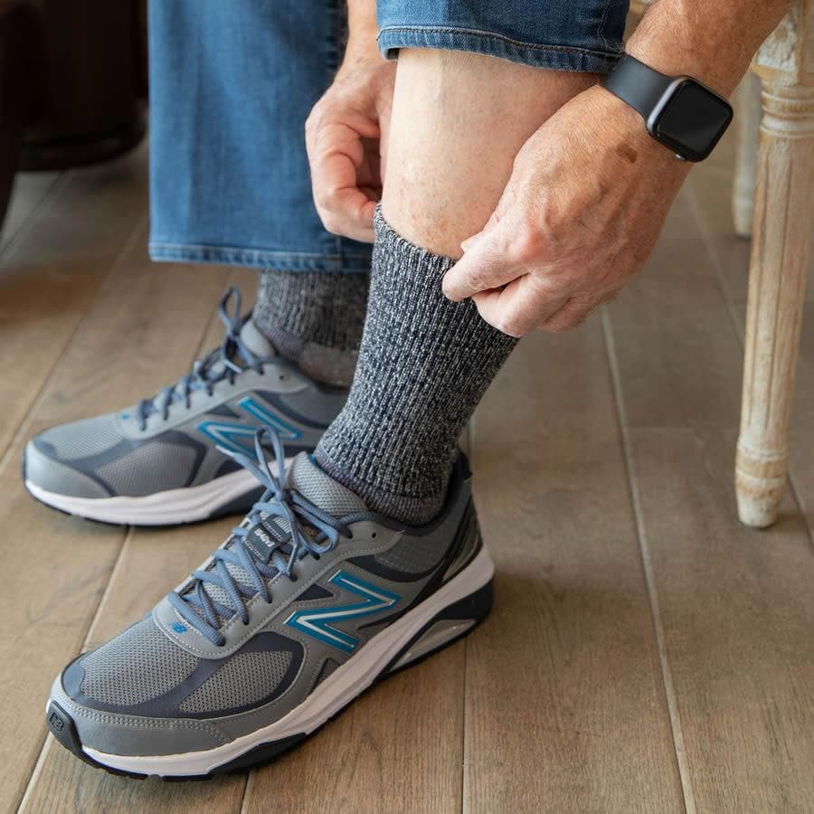 Man in sneakers pulling up an extra wide merino sock - The Sockery