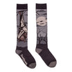 A pair of crew socks with a spooky Halloween theme, featuring a bat hanging from a tree branch on one sock and a full moon, bats, and bare trees on the other, in dark gray and black with a light gray sole.