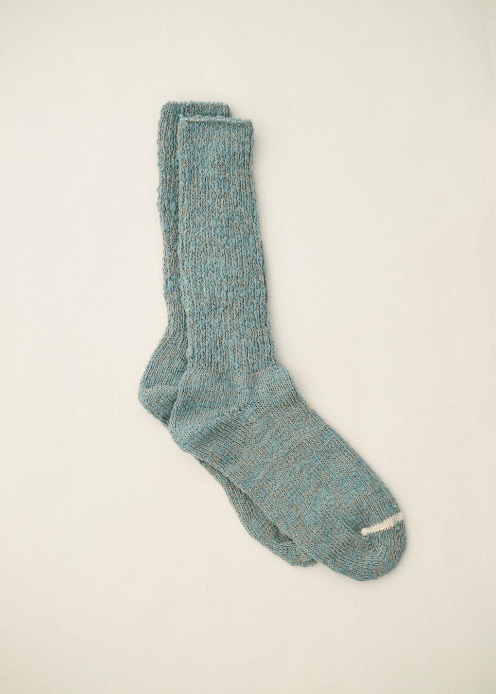 Pair of blue socks on a beige background