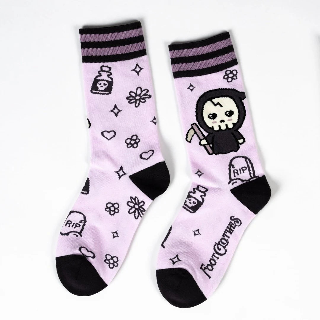 Pair of socks with cartoon character and symbols on a light purple background