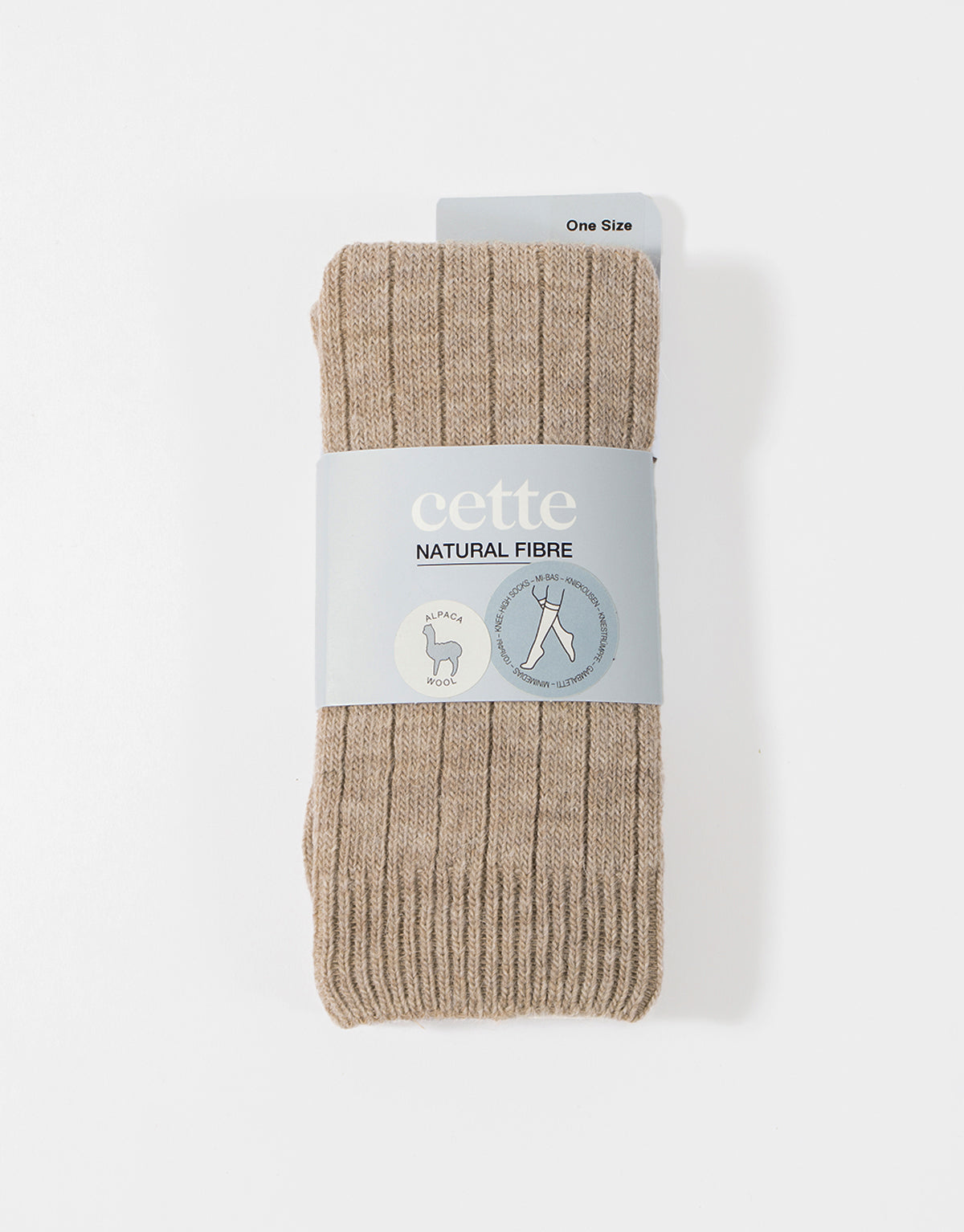 Pair of beige socks with a 'cette' label on a white background